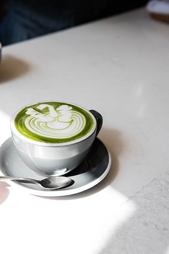 Matcha Latte In A Grey Mug On A White Table