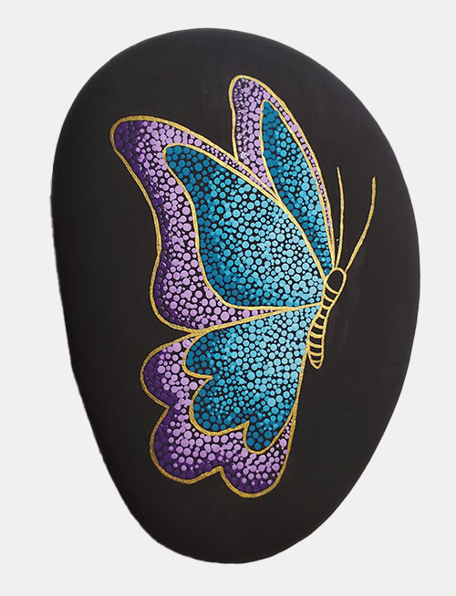 hand painted rock of dotted butterfly