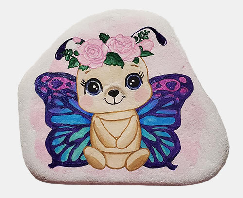 hand painted rock of a cute butterfly dog