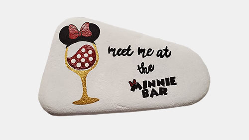 hand painted rock of a glass of wine with Minnie ears and text meet me at the Minnie Bar