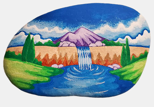 hand painted rock of a mountan and waterfall