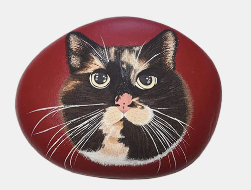 hand painted rock of a cat